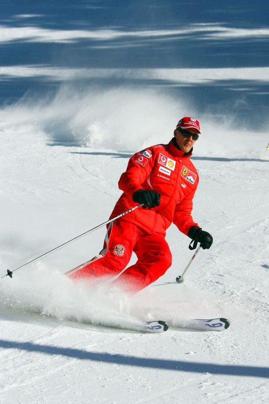 a man riding skis down a snow covered slope