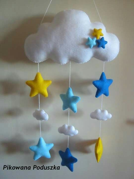 a cloud and stars mobile hanging from the ceiling