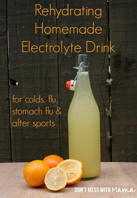 a bottle of homemade electrolyte drink next to oranges