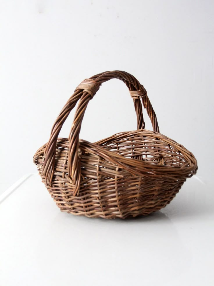 a wicker basket sitting on top of a white table