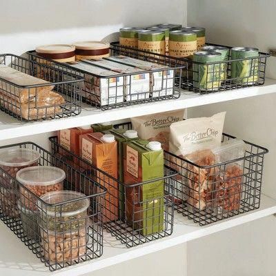 the shelves are organized with baskets and food