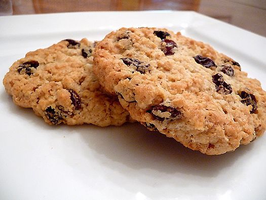 two oatmeal cookies sitting on top of a white plate