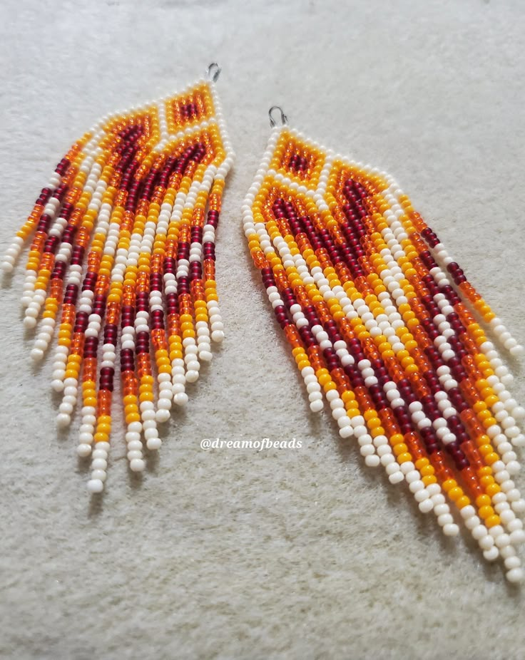 two pairs of beaded earrings with white and orange beads