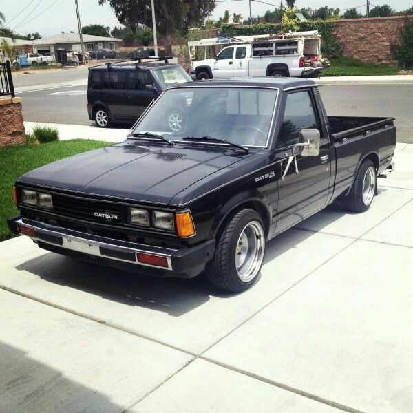 a black pick up truck parked on the sidewalk