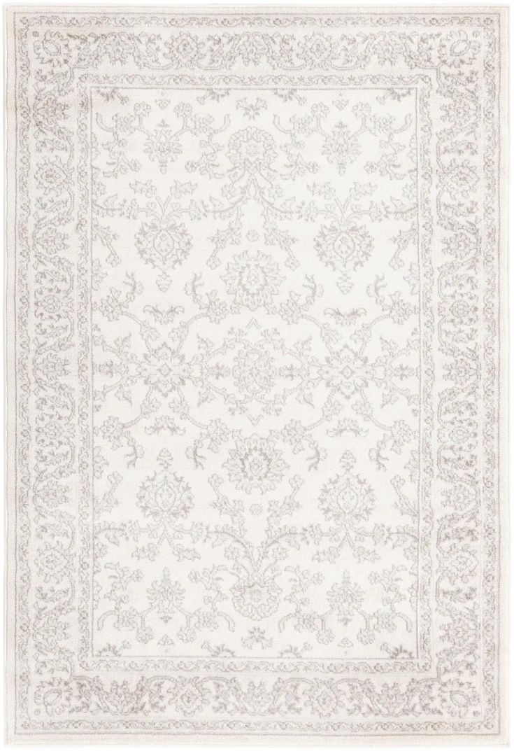 a white rug with an intricate design on the top and bottom, in grey tones