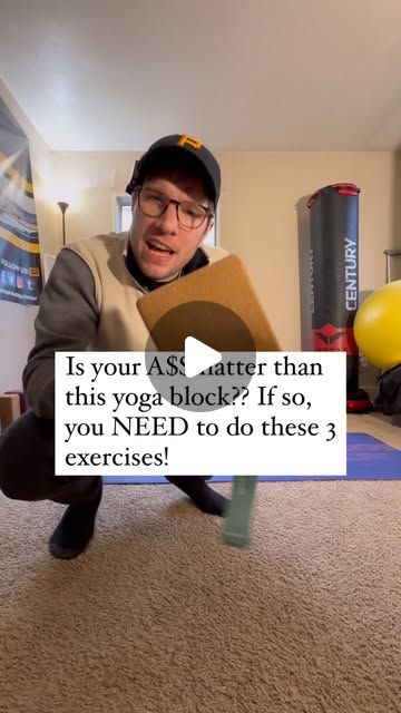 a man kneeling on the floor with a yoga mat