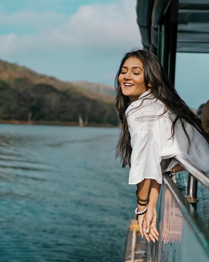 a woman standing on the edge of a boat