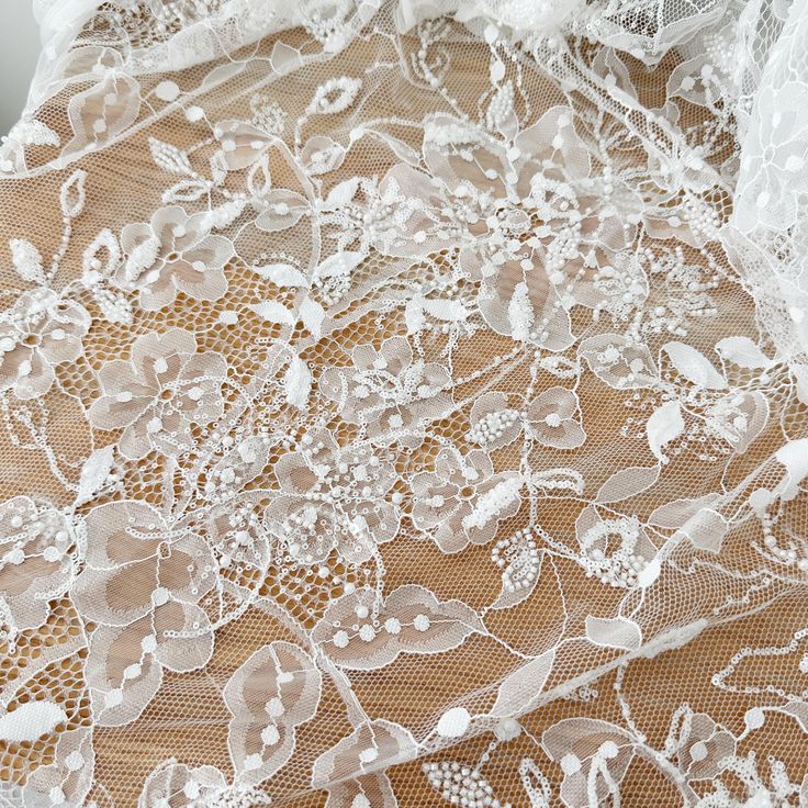 white lace fabric with flowers and leaves on it