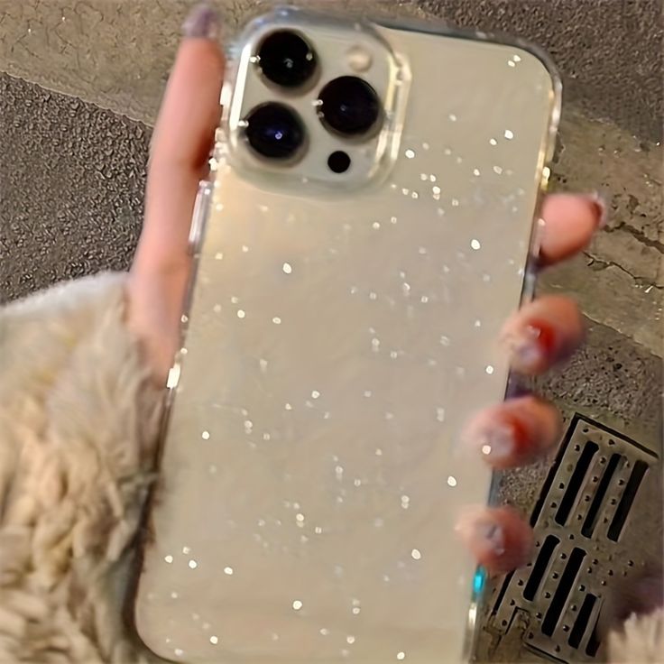 a woman holding up her phone case with water on the front and back cover in clear