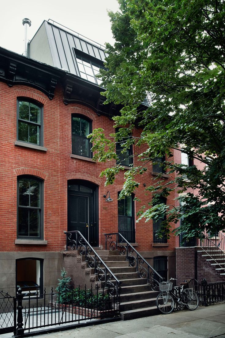 an apartment building with stairs leading up to the front door