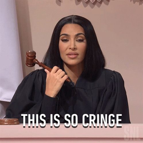 a woman sitting at a table with a judge's gavel in her hand