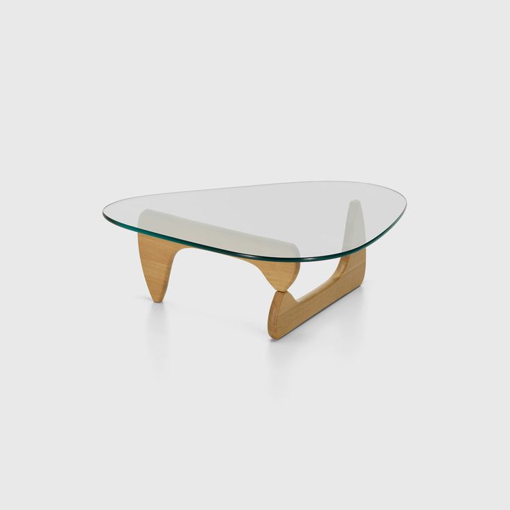 an oval glass coffee table with wooden legs