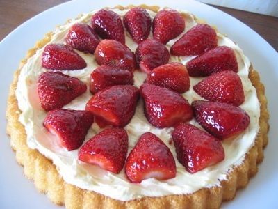 a cake with strawberries on top is sitting on a plate