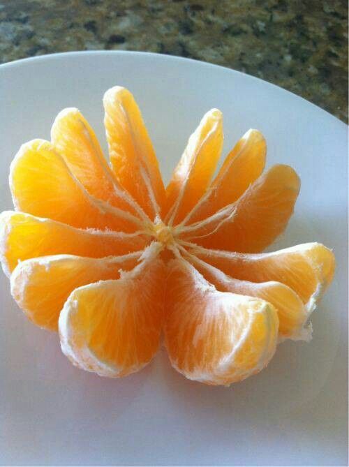 an orange is cut in half on a plate