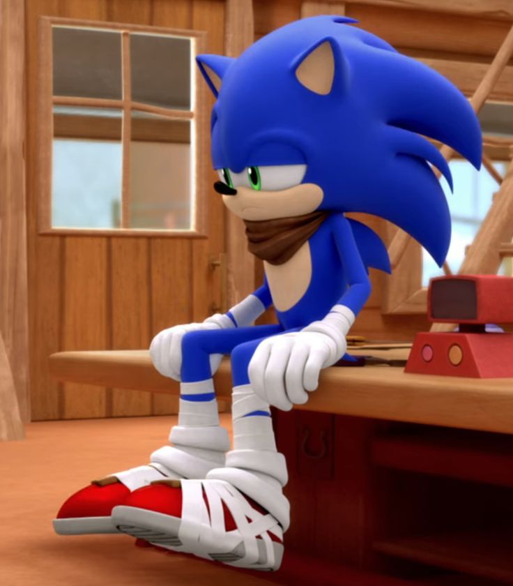 sonic the hedgehog is sitting on top of a desk