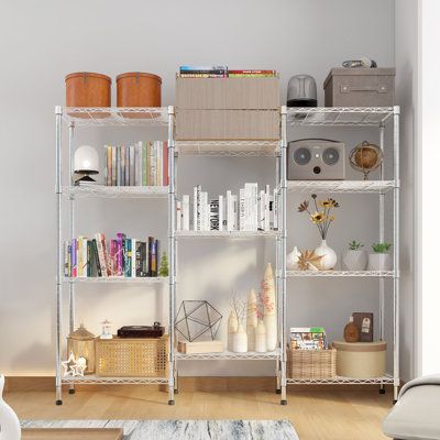 a living room filled with lots of furniture and bookshelves on top of each other