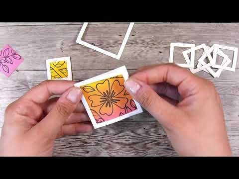 someone is making some paper flowers out of cutout shapes on a wooden surface with their hands