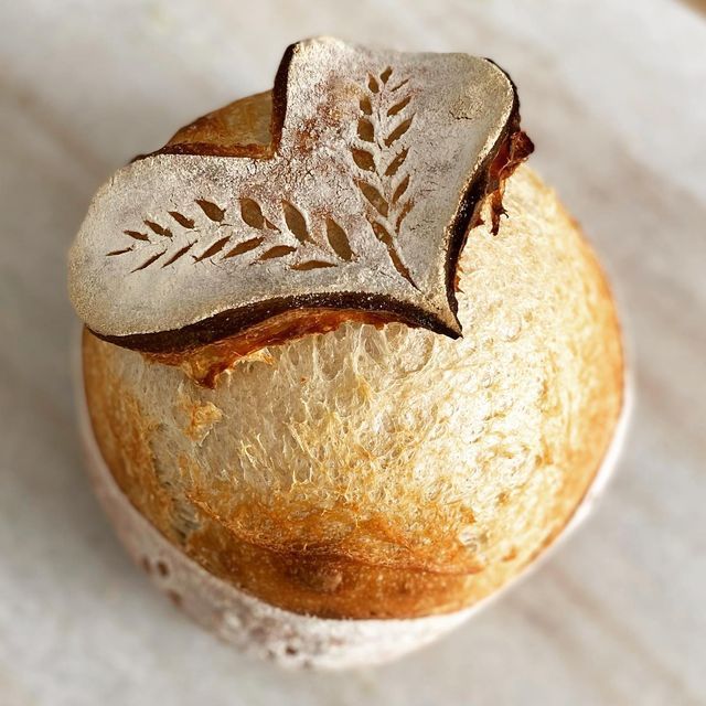 a loaf of bread with a leaf design on it