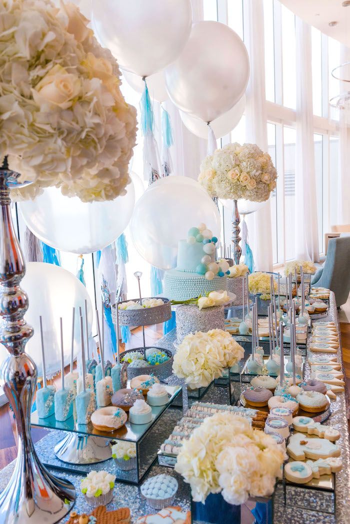 a table topped with lots of desserts and balloons