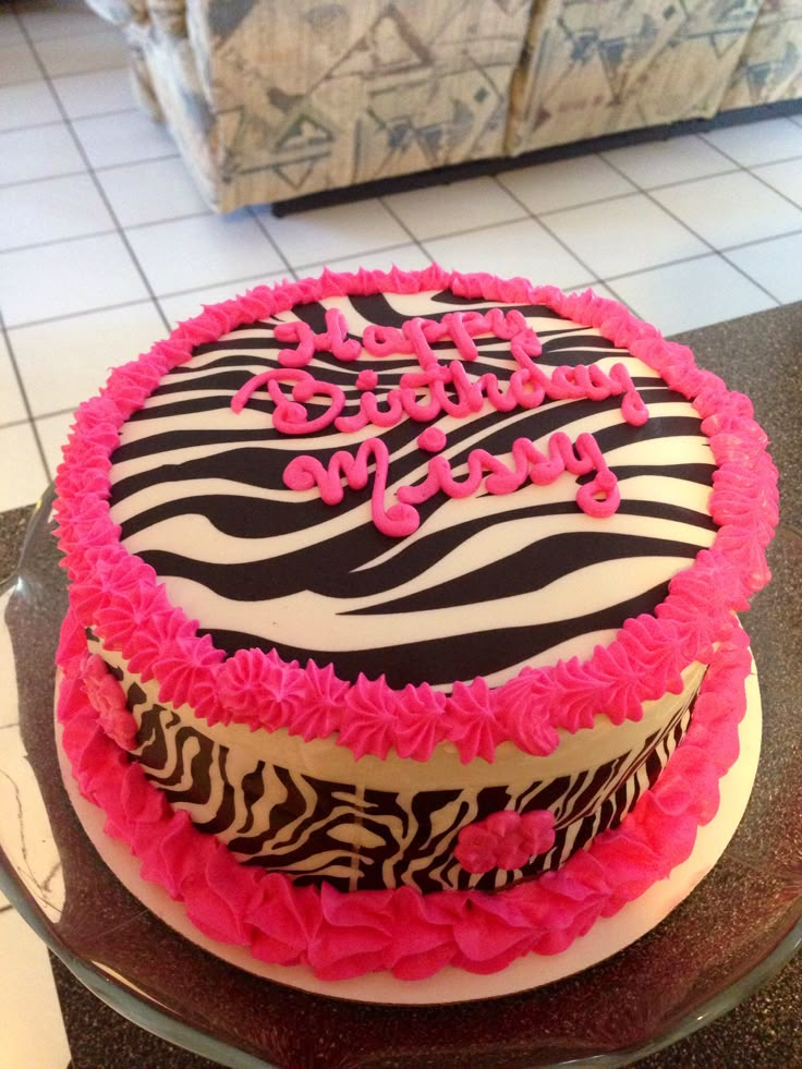 a zebra print birthday cake with pink frosting