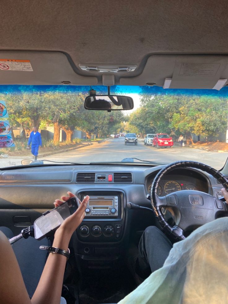 two people in a car driving down the road