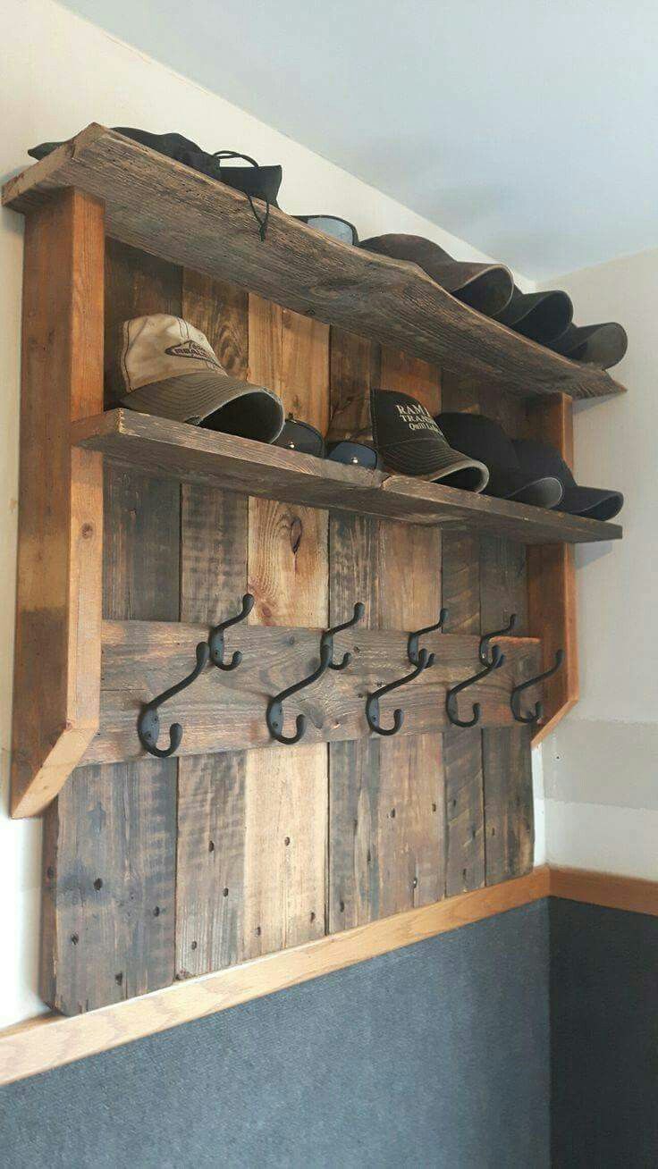 a wooden shelf with shoes on top of it and hooks hanging from the wall above