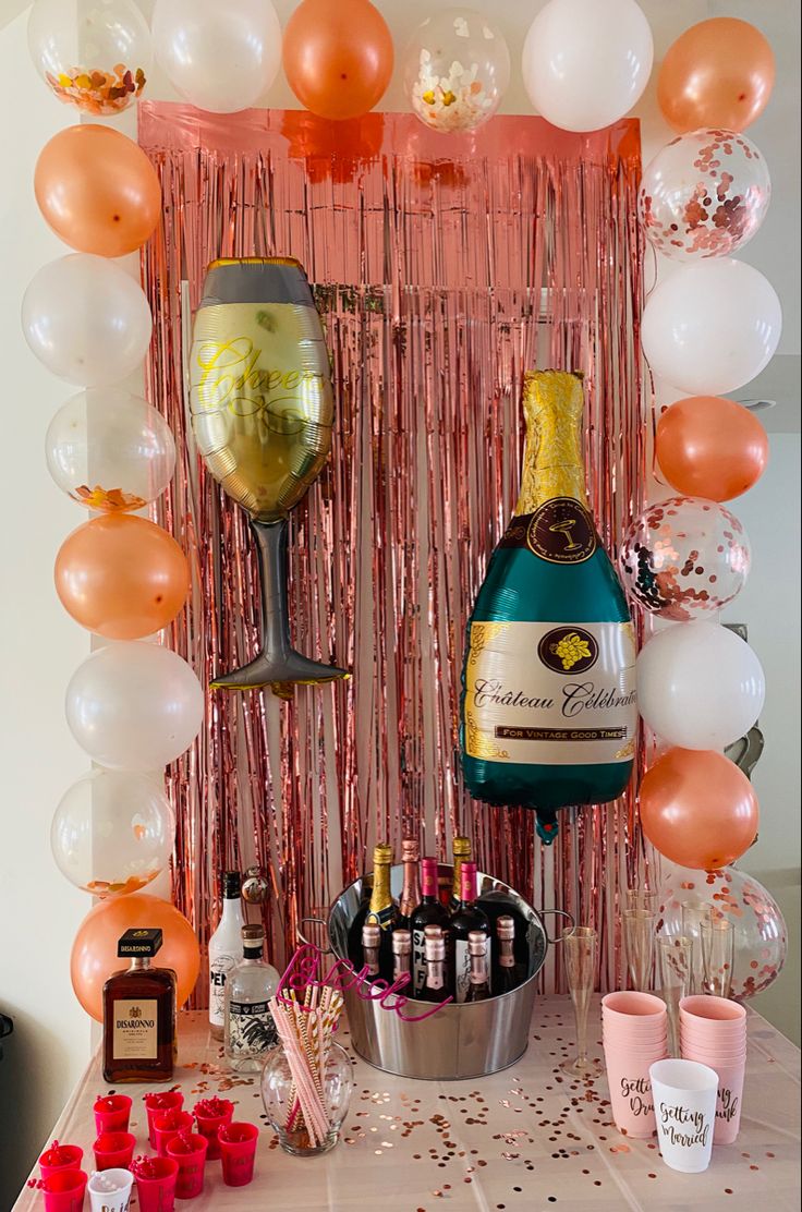 a table topped with champagne bottles and balloons