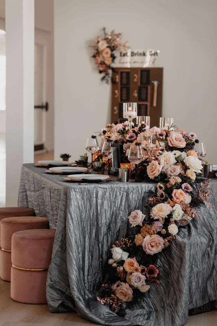 a table with flowers and candles on it