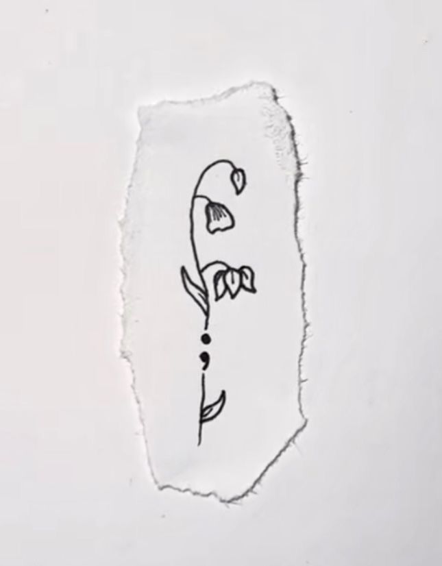 a piece of paper with a drawing of a flower on it's left side