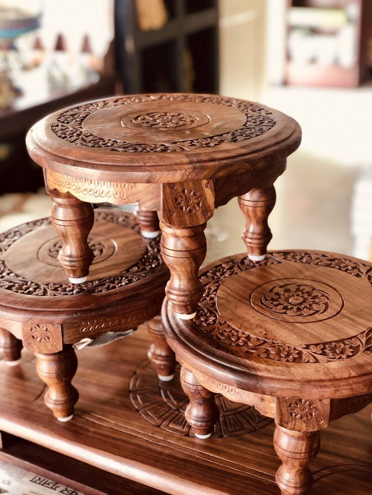 three wooden stools sitting on top of a table