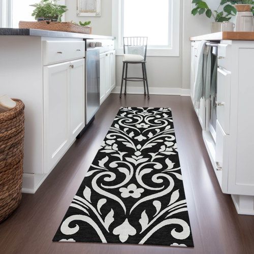 a black and white runner rug in a kitchen