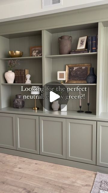 a living room filled with lots of gray bookshelves and vases on top of them