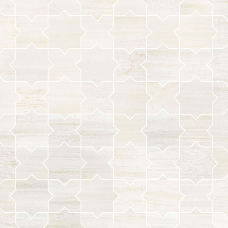 a white tile wall with an abstract pattern