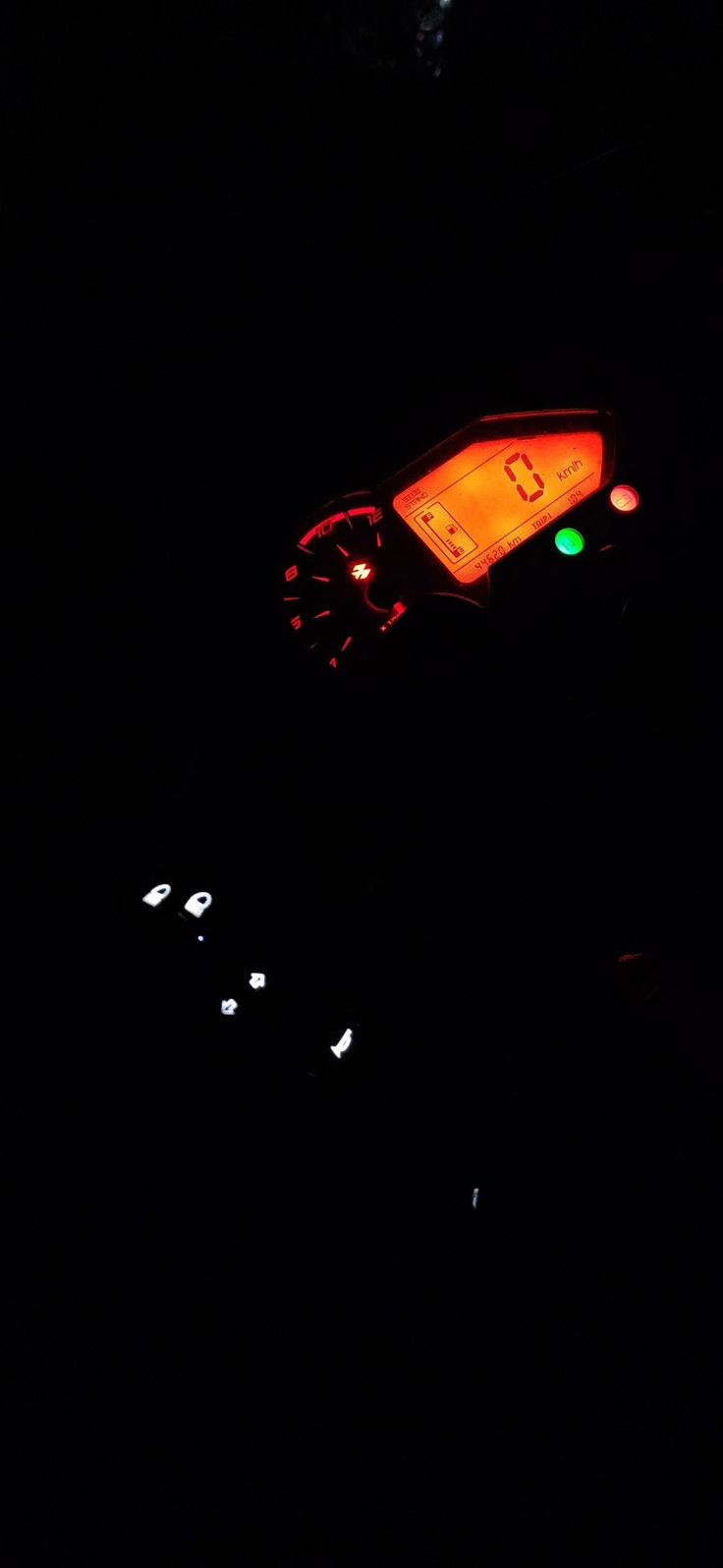 a traffic light that is red and green in the dark night time with lights on it