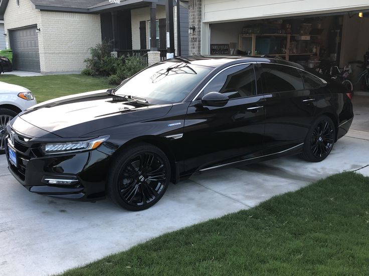 a black car parked in front of a house