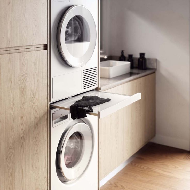 a washer and dryer sitting next to each other on top of a counter