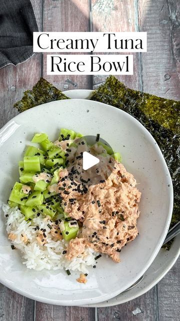 a white bowl filled with rice and meat on top of a wooden table next to broccoli