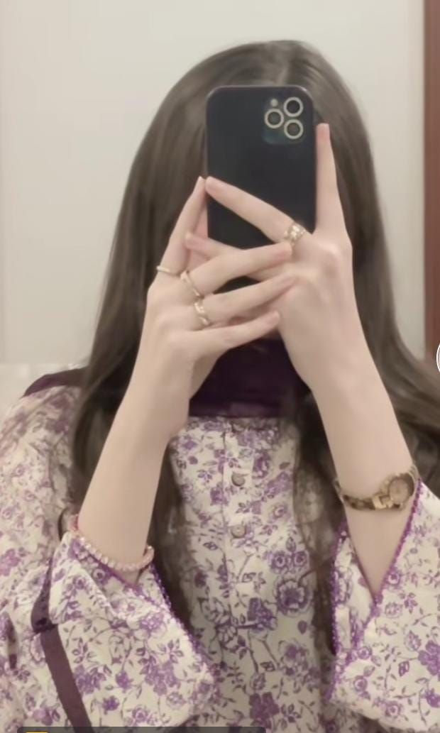 a woman is taking a selfie with her cell phone in front of her face