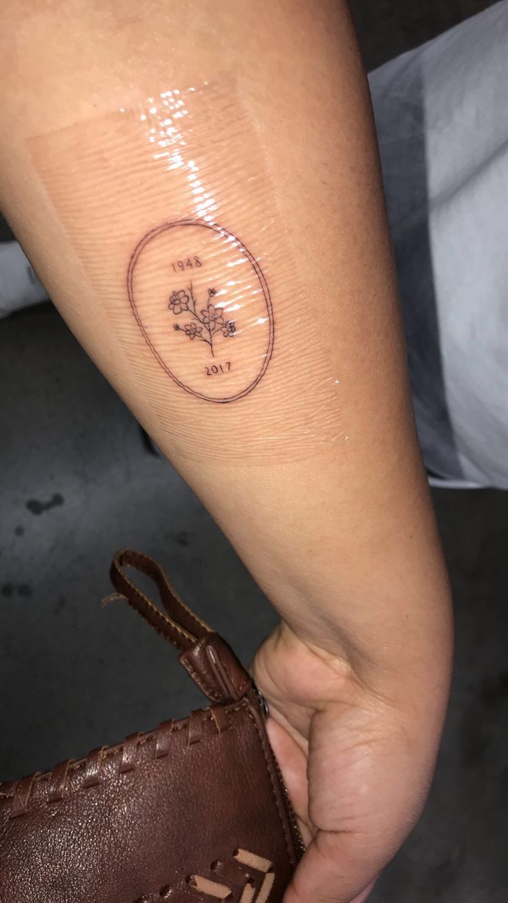 a person with a small tattoo on their arm