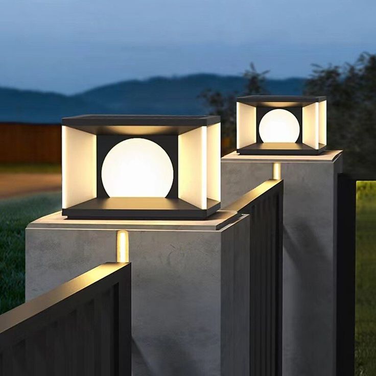 two lights that are on top of cement blocks