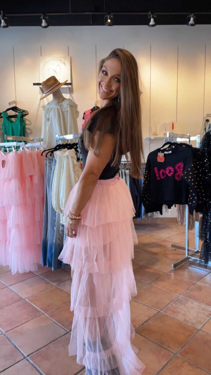 This Pink Princess Train Skirt is sure to make any girl feel like royalty. Crafted with layers of light pink tulle, this skirt features a full train for the ultimate girly look. Whether it's for a fun day out or a special event, this skirt is sure to make an impression. I've paired it with our buttery soft ruffled sleeve bodysuit. Available in S-XL while supplies last. If you prefer black, we have the sister skirt with silver sparkly moons and stars! I'm wearing a small. Caroline is wearing a me Train Skirt, Moons And Stars, Pink Tulle, Fun Day, Pink Princess, Days Out, Special Event, Special Events, Light Pink