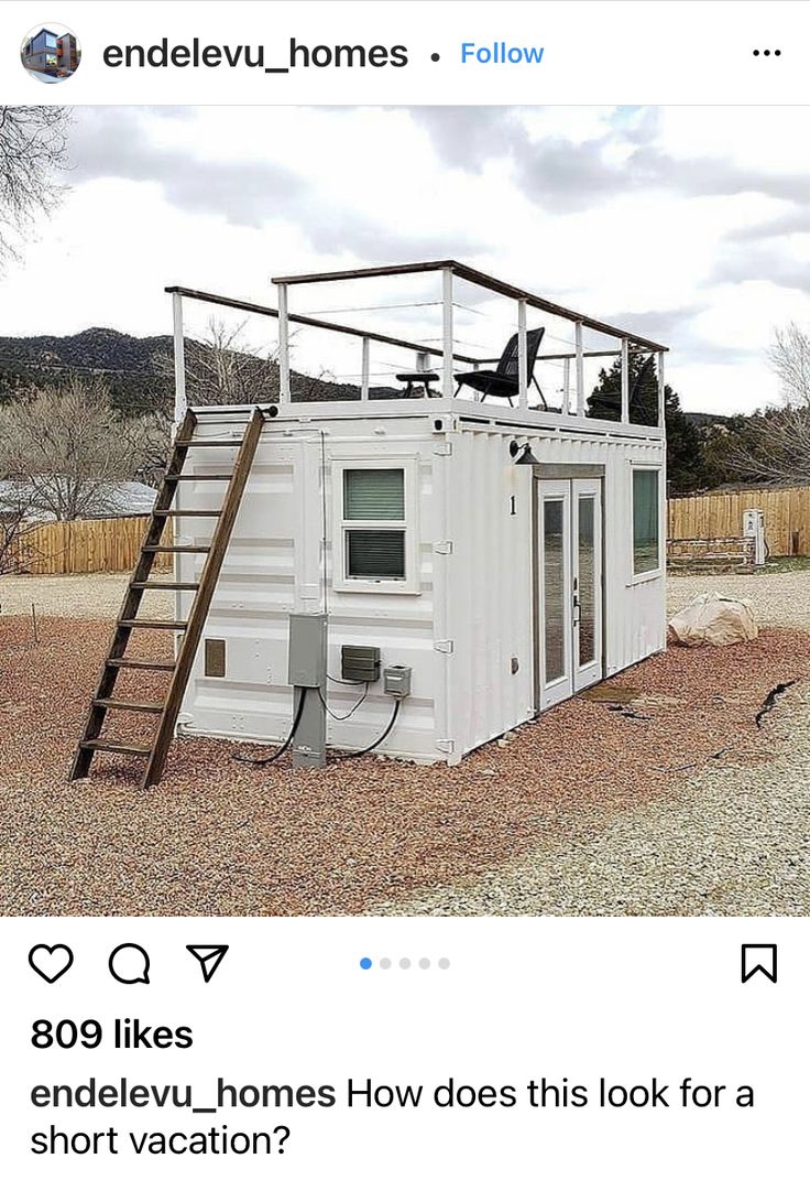 a small house made out of a shipping container with a ladder going up to the roof