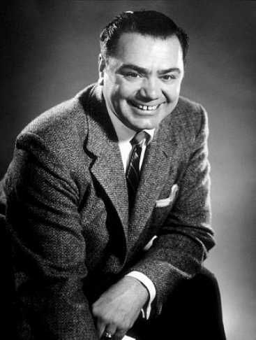 a black and white photo of a smiling man