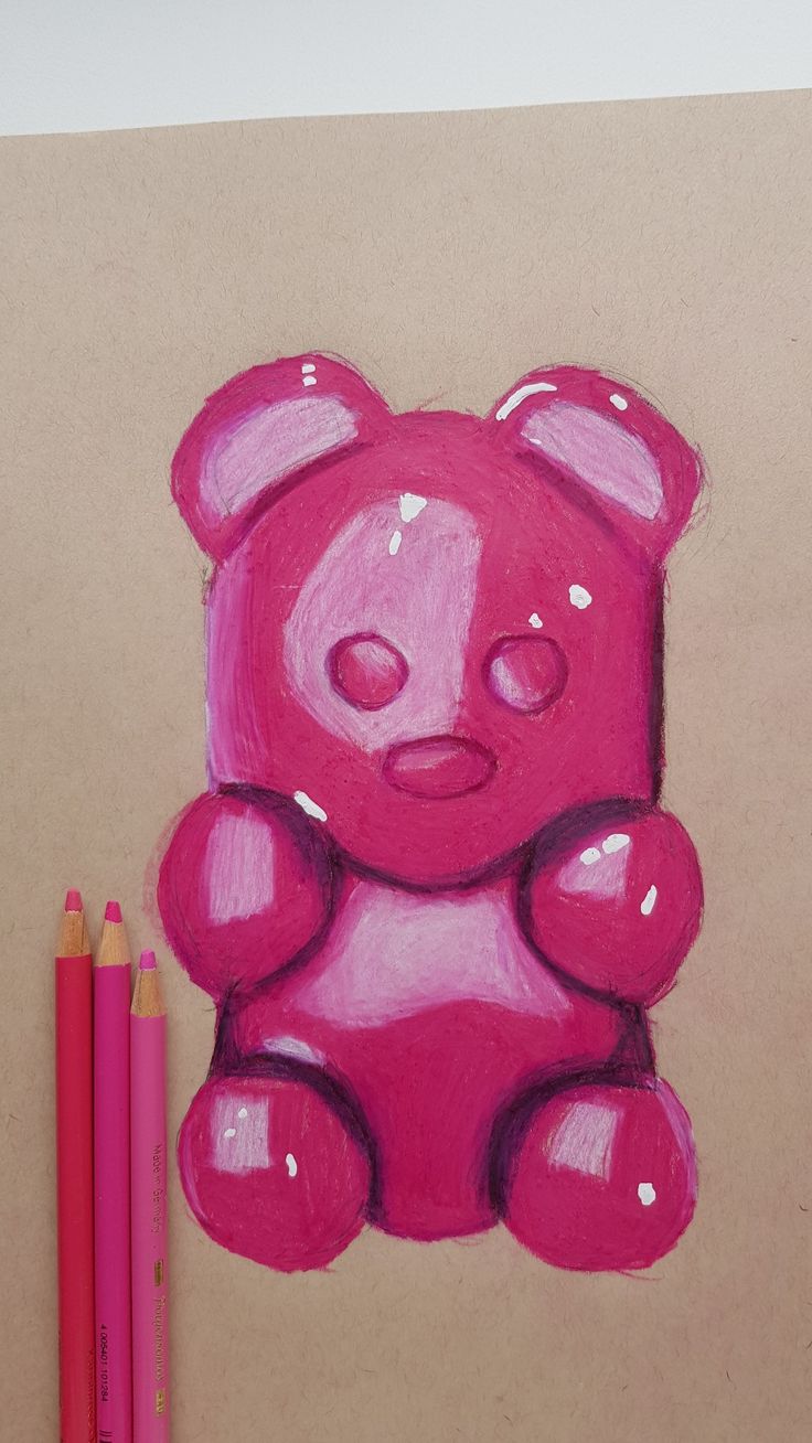 a drawing of a pink teddy bear next to two colored pencils