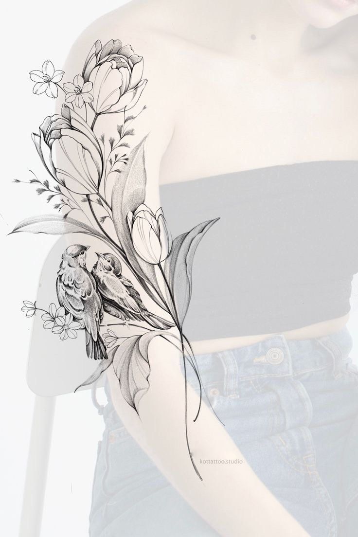 a woman's arm with flowers and leaves drawn on the back of her shoulder