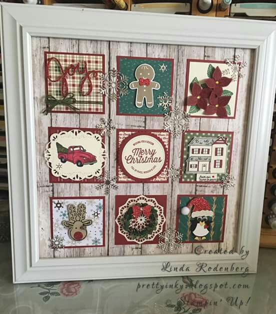 a white frame with christmas cards in it on top of a table next to other items