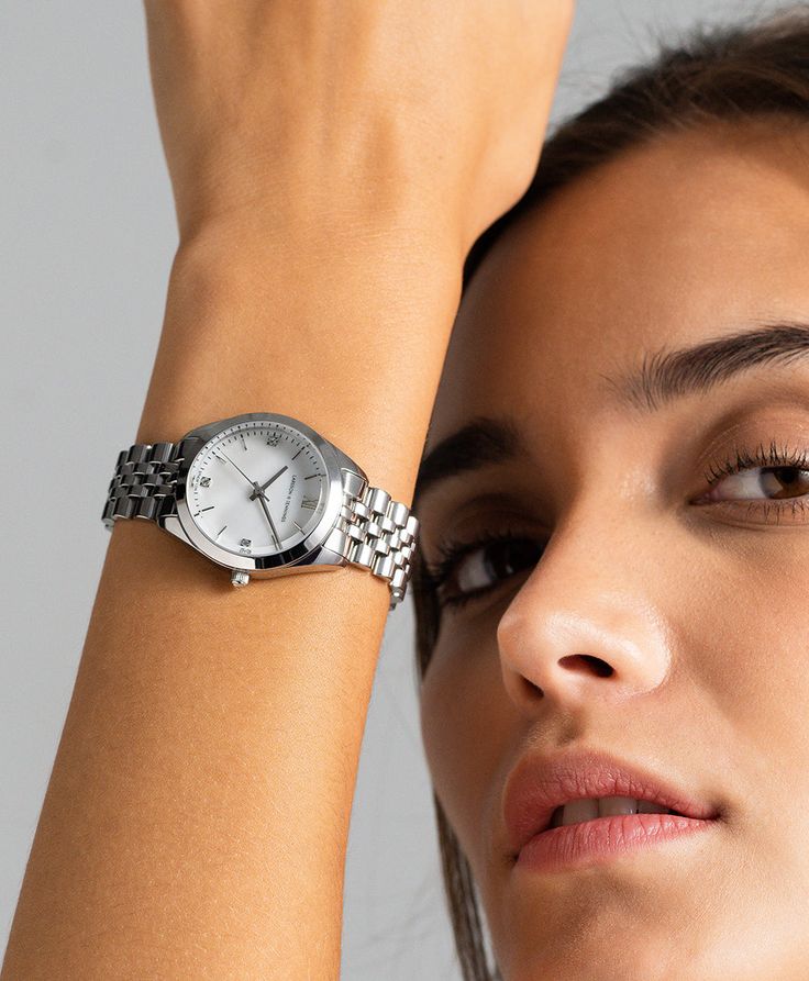 A classic design, elevated. The bold and urban Vivid watch features a statement round face with chunky outer casing that’s juxtaposed by the delicate pearlescent dial, minimalist numerals and crystal detailing. In striking silver with a 32mm face, Vivid pairs androgynous design with robust links made of stainless steel for effortless sophistication. Metallic Watches Women, Silver Watch For Women, Women Watches Classy Elegant Silver, Silver Watches, Suits Outfits, Silver Watches Women, Watch Trends, White Watch, Ladies Watches