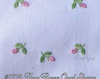 embroidered flowers and leaves on white fabric with words in green lettering that read, the tiny roses craft shop