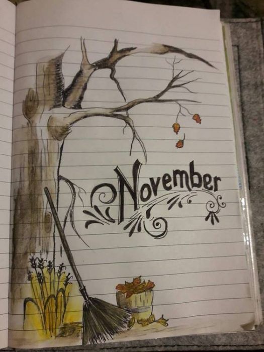 an open notebook with the words november written in black and white on it, next to a drawing of a tree