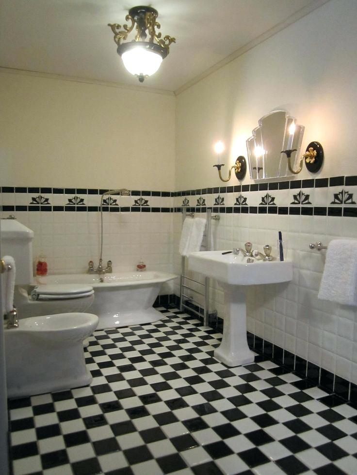 a black and white checkered floor in a bathroom with two sinks, toilet and bathtub